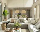 Salón y cocina integrados con **estilo moderno decoración**. Sofá modular beige, cestas de mimbre, plantas y lámparas de fibras naturales.