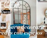 Ideas para decorar paredes con espejos: un espejo antiguo sobre chimenea, uno industrial sobre sofá azul y uno redondo sobre mesa de mármol.