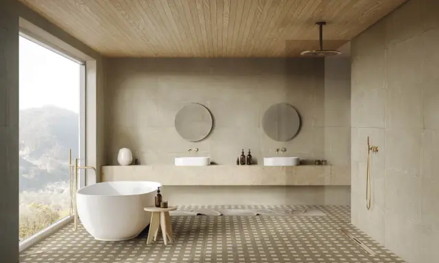 Elegante baño con bañera exenta, lavabos dobles y ducha. Las paredes y el suelo combinan baño color beige y madera, creando un ambiente sereno.