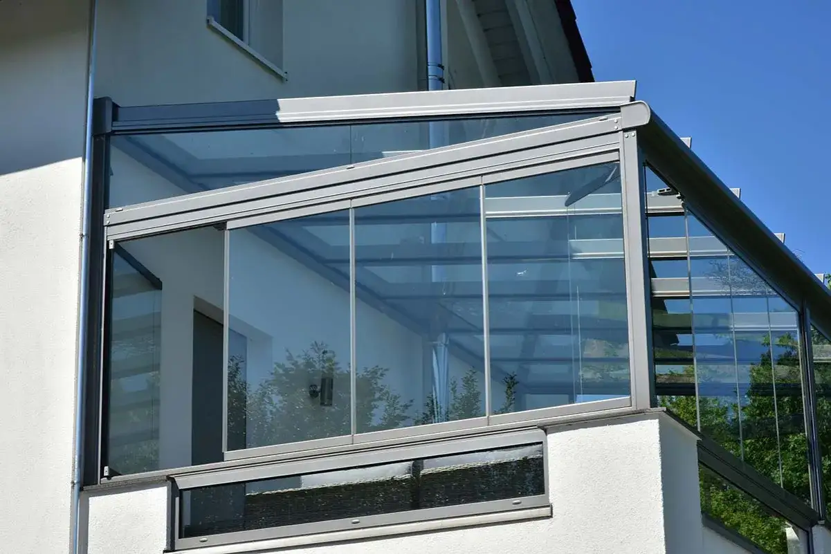 Modern glass enclosure transforms a terrace into a bright, usable room.